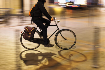 bicycle rider on the move in the city at night
