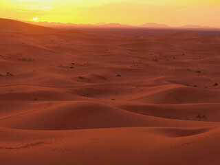 Fototapeta na wymiar Amazing view of a gorgeous sunset over sand dunes of the Sahara desert, Morocco