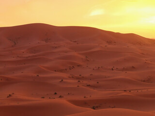 Fototapeta na wymiar Amazing view of a gorgeous sunset over sand dunes of the Sahara desert, Morocco