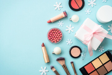 Winter cosmetic with holiday decorations on blue.