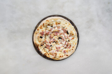 pizza carbonara top view on a white stone