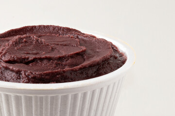 Frozen açaí in a bowl isolated on white background.