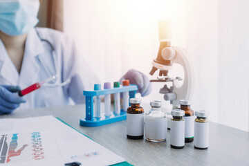 Fototapeta premium biochemical research scientist team working with microscope for coronavirus vaccine development in pharmaceutical research labolatory, selective focus