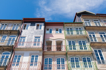 Fototapeta na wymiar Oporto cityscape with colourful facades of old balconies landmark on a blue sunny sky in Oporto, Portugal