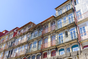 Fototapeta na wymiar Oporto cityscape with colourful facades of old balconies landmark on a blue sunny sky in Oporto, Portugal