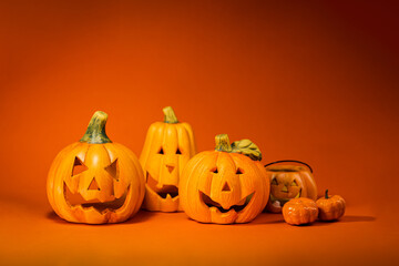 A set of jack o lantern pumpkin decoration on orange background