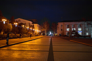 KERCH, Crimea people walk next on Lenina square in Kerch at night