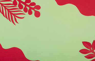 green background with red paper flowers and plants