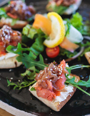 Catering table with salmon bruschetta, beautifully decorated banquet with food snacks appetizers on corporate birthday party event or wedding celebration, canape, delicatessen setting