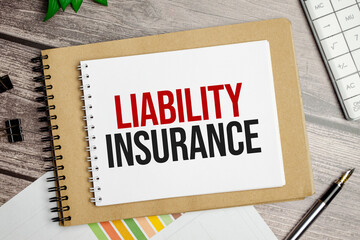 LIABILITY INSURANCE words on notepad and pen with charts