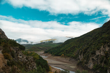 Nearly dry reservoir in autumn, October 2022. Effects of climate change such as desertification and droughts. In the Pyrenees of Catalonia, Spain.