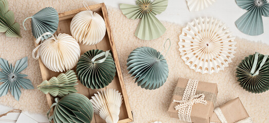 Scandinavian christmas paper honeycomb ornaments in the box and gifts. Modern sustainable christmas...
