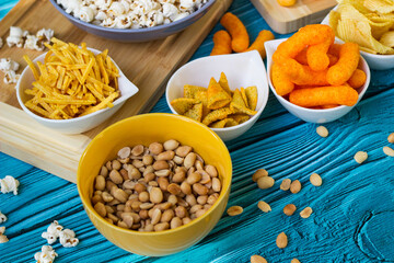 Beer salty snacks on wooden table