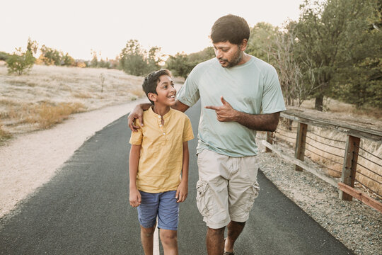 A Father talking to his step son outdoors 