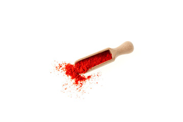 Red pepper ground in wooden scoop on white background, top view. Dried Red Chili Pepper or Paprika powder