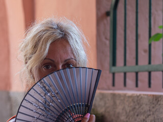 caucasian young woman with folding fan