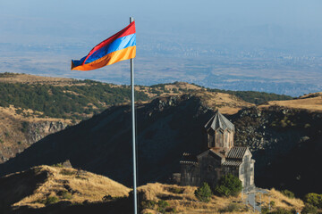 View of waving flag of Armenia with mountain landscape in the background, armenian tricolor flag in...