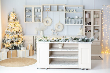 Christmas decorated light kithen. Pastel white and beige colors. Modern stylish interior of kitchen decorated for New Year Eve. Christmas morning