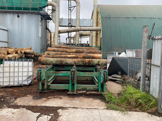 Industrial sawmill with logs for processing into boards, equipment for logging and making wood products
