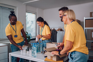 Group of multiracial volunteers working in community charity donation center