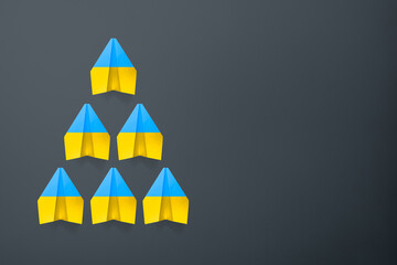 Paper airplane Ukraine flag colors background. flight along the trajectory behind the leader. aid...