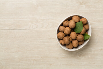 Fresh walnuts on wooden background, top view