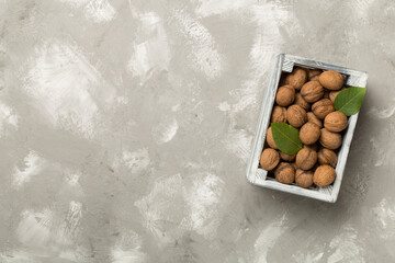 Fresh walnuts on wooden background, top view