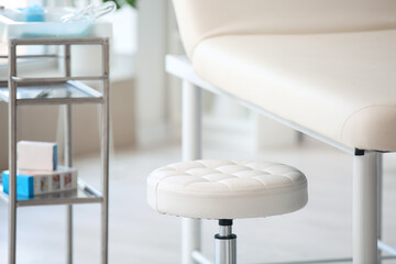 Modern couch and stool in medical office, closeup