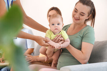 Female speaker with little baby giving course for expectant mothers in class
