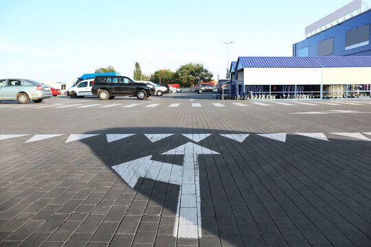 Direction mark on parking lot near supermarket