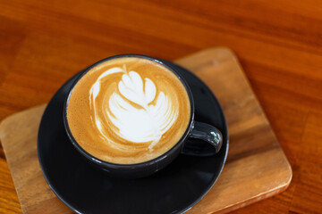 hot latte art coffee on wood table, relax time