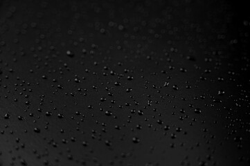 Water droplets on the floor with black background
