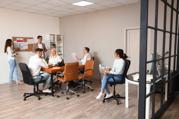 Business co-workers giving presentation during meeting in office