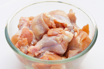 Fresh raw chicken wings (wingstick) in white plate on yellow background.