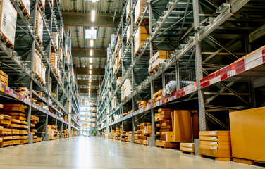 View from the floor in a large warehouse in the aisle between the shelves and racks