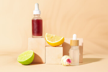 Composition with bottles of vitamin C serum and decor on color background