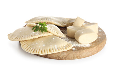 Board with raw chebureks, parsley and pieces of dough on white background