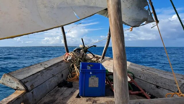Zanzibar Island, Tanzania dhow boats sailing against a blue sky with clouds. First Person Point of view