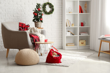 Obraz premium Stylish interior of living room with Santa bag and gifts