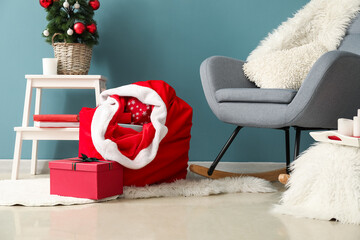 Stylish interior of modern living room with Santa bag and gifts