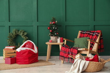 Stylish interior of modern living room with Santa bag, gifts and Christmas tree