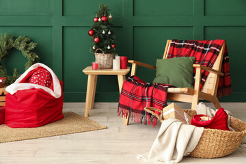 Stylish interior of modern living room with Santa bag, gifts and Christmas tree