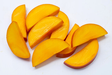 Mango fruit slices on white background.