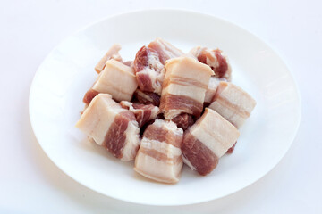 Streaky pork in white plate on white background.
