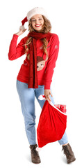 Young woman in Santa hat with bag on white background