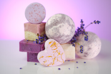 Lavender soap.Bars of purple soap and lavender flowers on a light purple background. set of soap and bade bombs with lavender extract