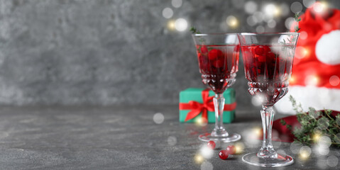 Delicious Christmas cocktail with liqueur on grey table, space for text. Banner design