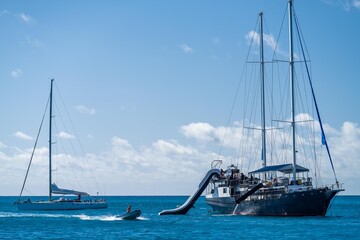 Tropical island in the Great Barrier Reef. coral reef, with yachts sailing. Boats and super yachts...