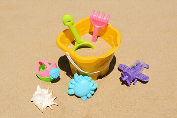 Fototapeta na wymiar Set of plastic beach toys on sand