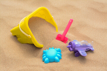Fototapeta na wymiar Set of colorful beach toys on sand